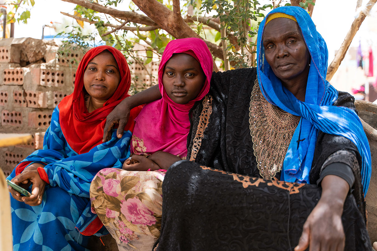 Aziza Ibrahim (right) is seen with with her daughters Amal (middle) and Eman (left). Aziza is now lives at the Abo Zaid Ahmed school, which was converted to a shelter to host displaced people from Khartoum, Sudan. Photo: OCHA/Ala Kheir