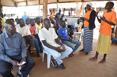 Tabu during a translation session in a meeting conducted in the refugee settlement. Photo/ UN Women Uganda