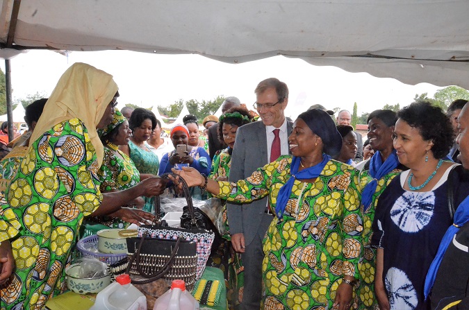 Minister Ummy Mwalimu, the UN Women Rep, Hodan Addou and the Swedish Ambassador, Anders Sjoberg share a lighter moment with some of the women manufacturing handbags displayed at one of the booths at an exhibition in Mwanza. UN Women/ Tsitsi Matope. 