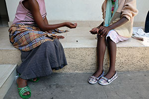 Two young girls play a game at the Safe House where they live in Adama. Photo: Felix Eldridge.