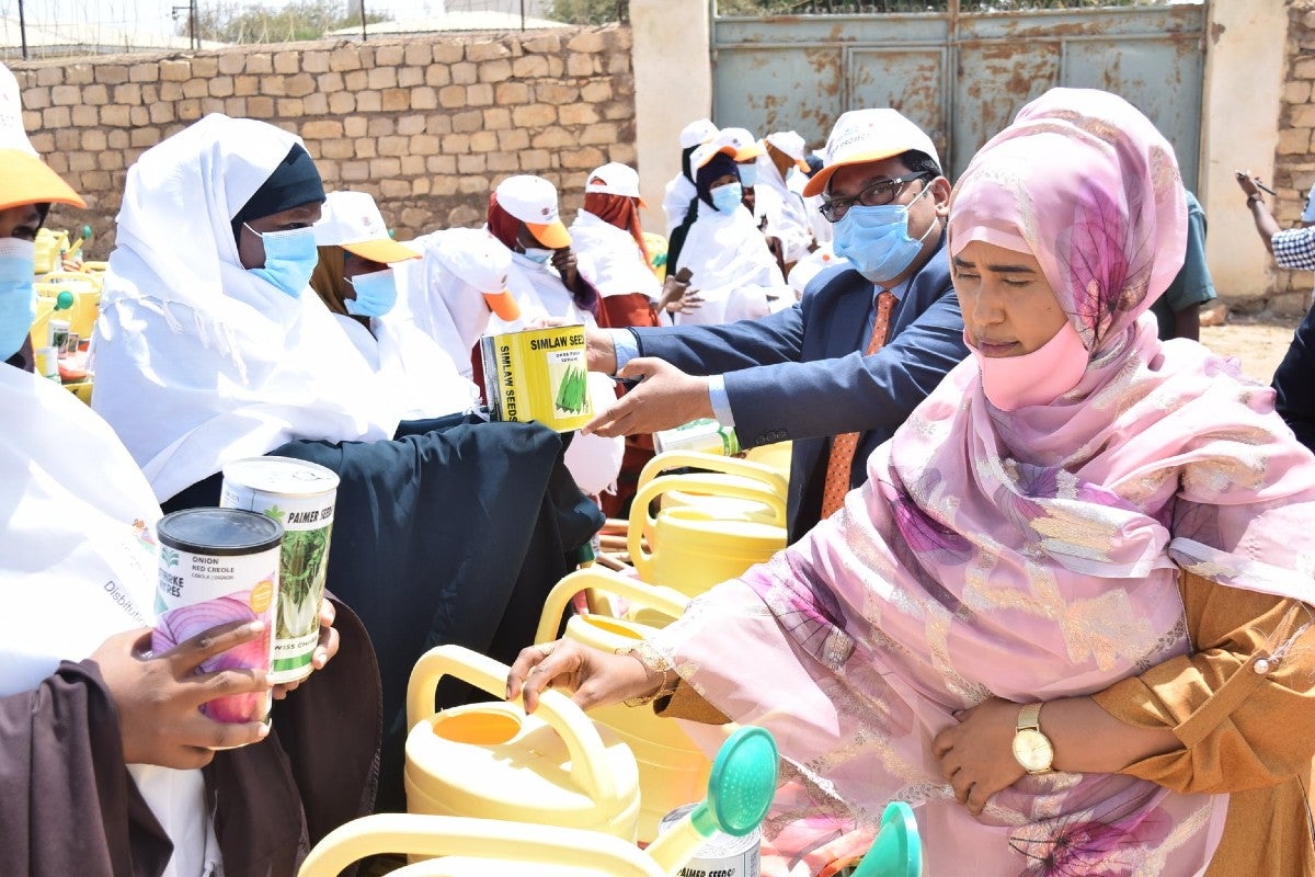 Minister Fahima and Dr. Syed distributing the tools to women