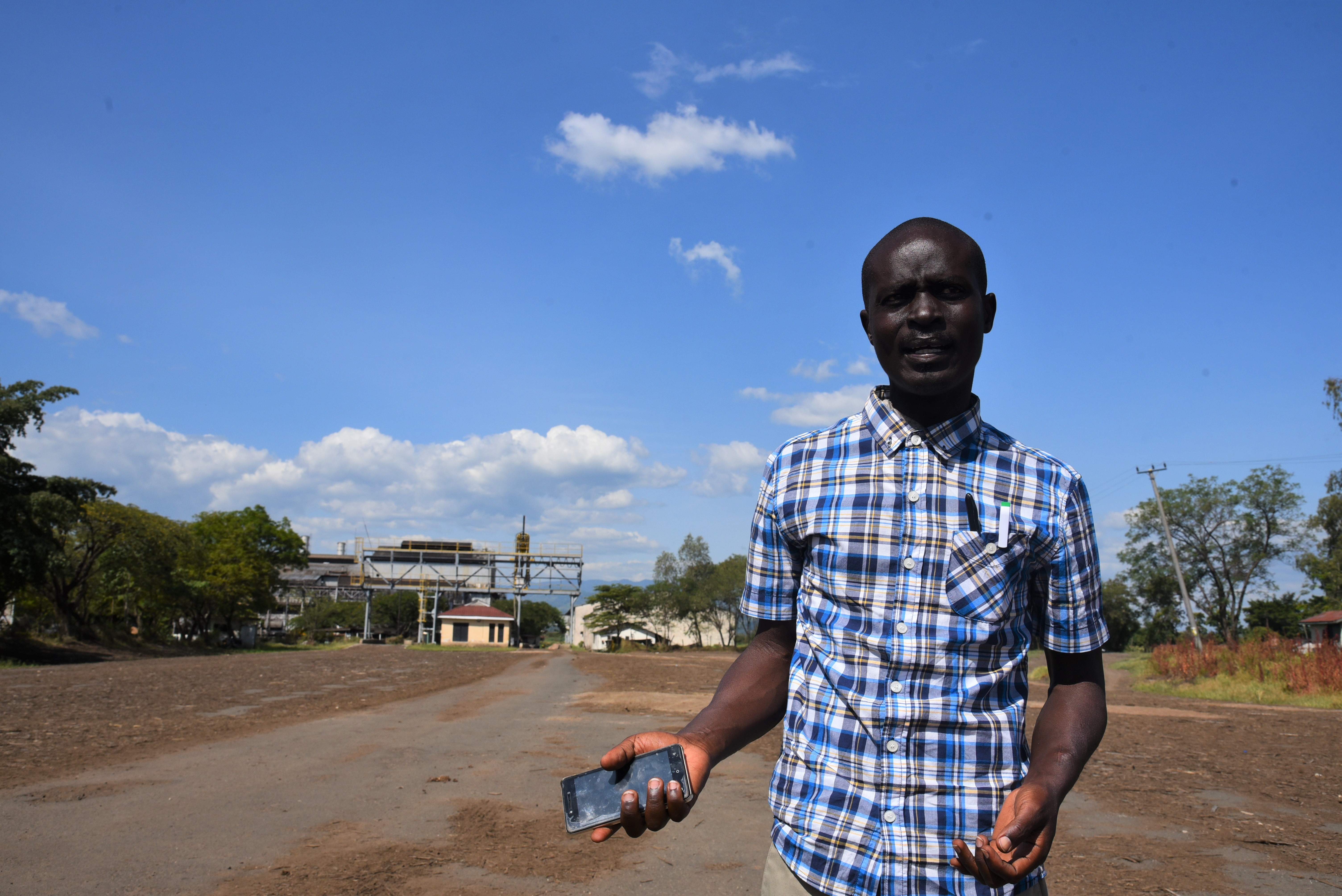 Oscar Ochieng, 35, explaining the region's conflict dynamics in front of a near-derelict sugar mill - one of the drivers of crime and stock theft. Photo: UN Women/Luke Horswell