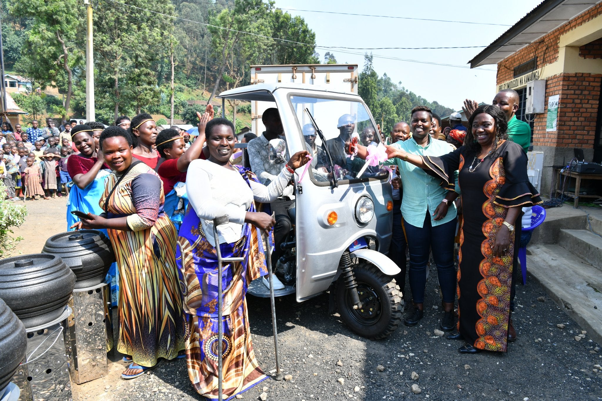 UN Women Country Representative, Ms. Jennet Kem and Vice Mayor in charge of Economic Development in Rubavu district, Ms. Deogratias Nzabonimpa handing over the tri-motor cycle to cooperative members. Photo: UN Women/Pearl Karungi.