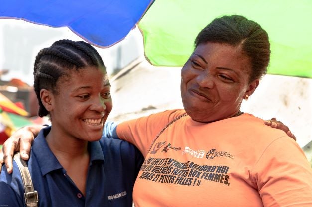 Elysse Tutakamuna (39), spices and vegetable seller at Mont Ngafula market, and her daughter