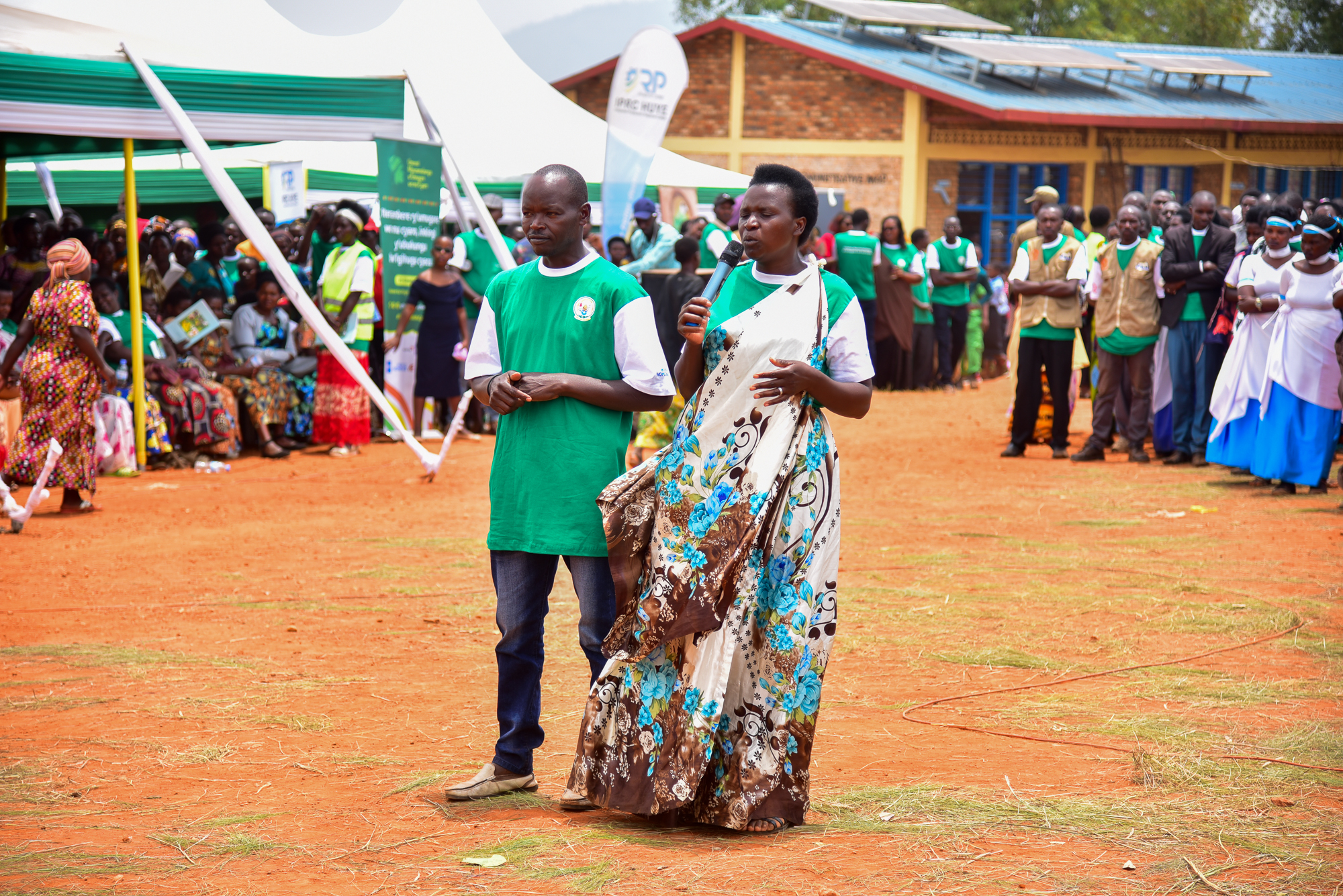 Circonstance Mukangira (left) gives her testimony about Village Savings and Loans Assosciations at the International Rural Women’s Day celebration. Photo: UN Women/James Ochweri