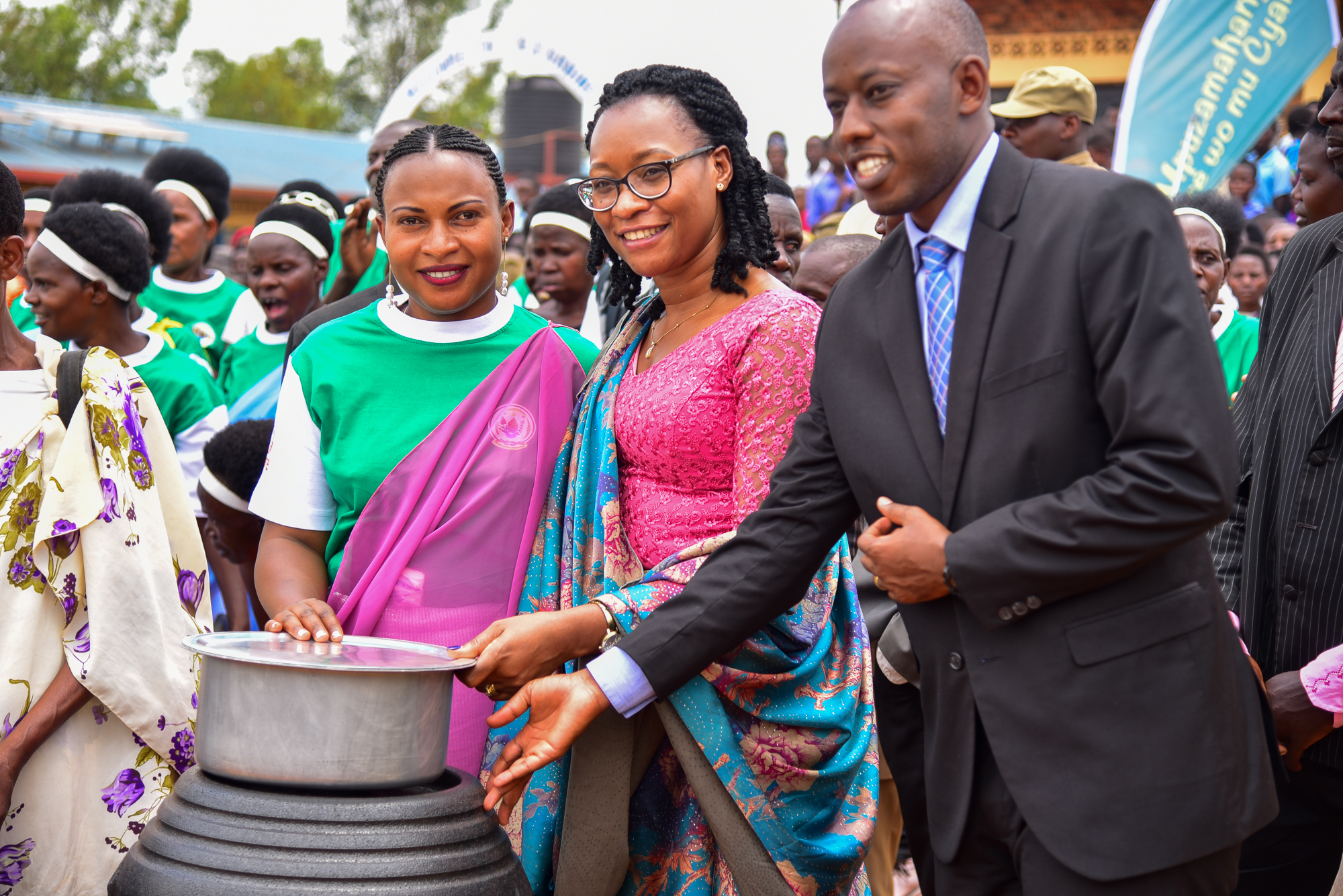 Prof. Bayisenge, Rwanda’s Minister of Gender and Family Promotion (center), and Sebutege Ange, the Mayor of Huye district (right) present an energy saving cooking kit to a beneficiary at the International Rural Women’s Day celebration. Photo: UN Women/James Ochweri