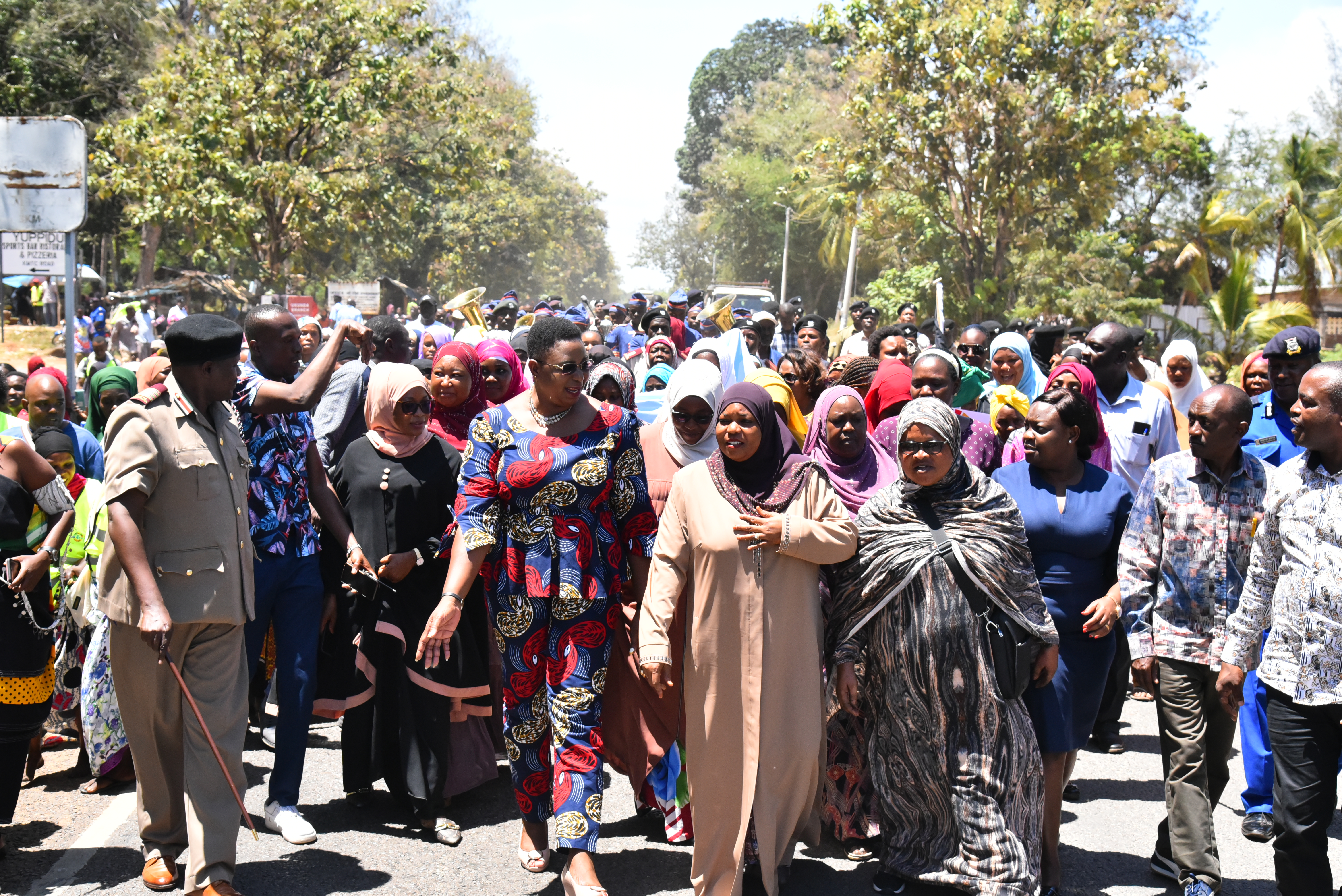 Governor Fatuma Achani (front centre) leading a march in Kwale County, alongside Kenya's Cabinet Secretary for Public Service, Gender and Affirmative Action, Aisha Jumwa (font left). Photo: UN Women/Luke Horswell