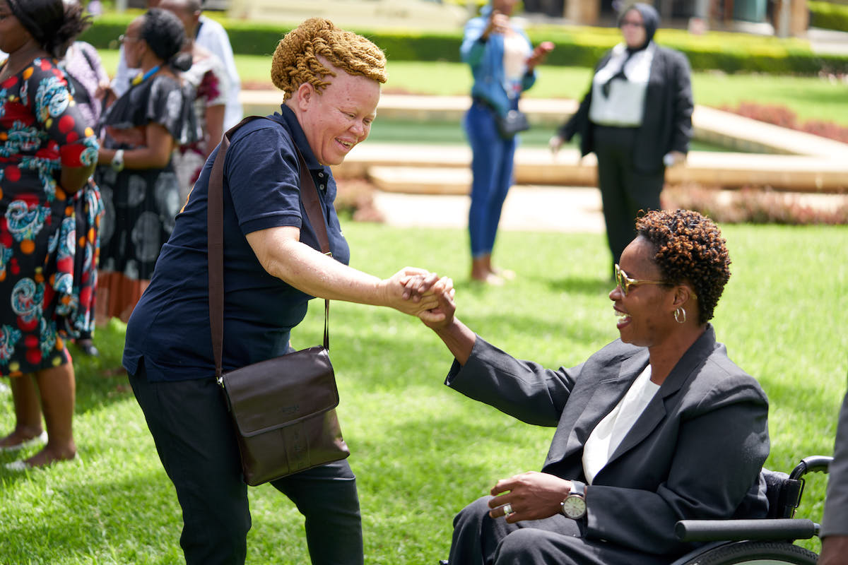 Embracing solidarity – members of MOWADITA greet each other at the national dialogue for women with disabilities held on the sidelines of International Day of People with Disabilities commemorations. Photo: UN Women