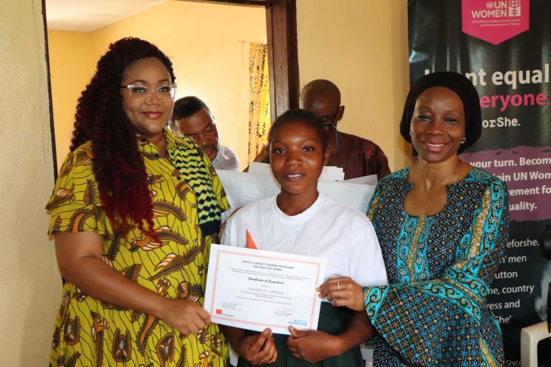 Graduate from Bong County in the north-central part of Liberia receives her certificate from Sara Buchanan, Executive Director of Orange Foundation Liberia (L) and Comfort Lamptey, UN Women Liberia Country Representative ® after completing a six month digital literacy skills training program facilitated by UN Women in collaboration with Orange Foundation. Photo credit @UN Women/ Gloriah Ganyani