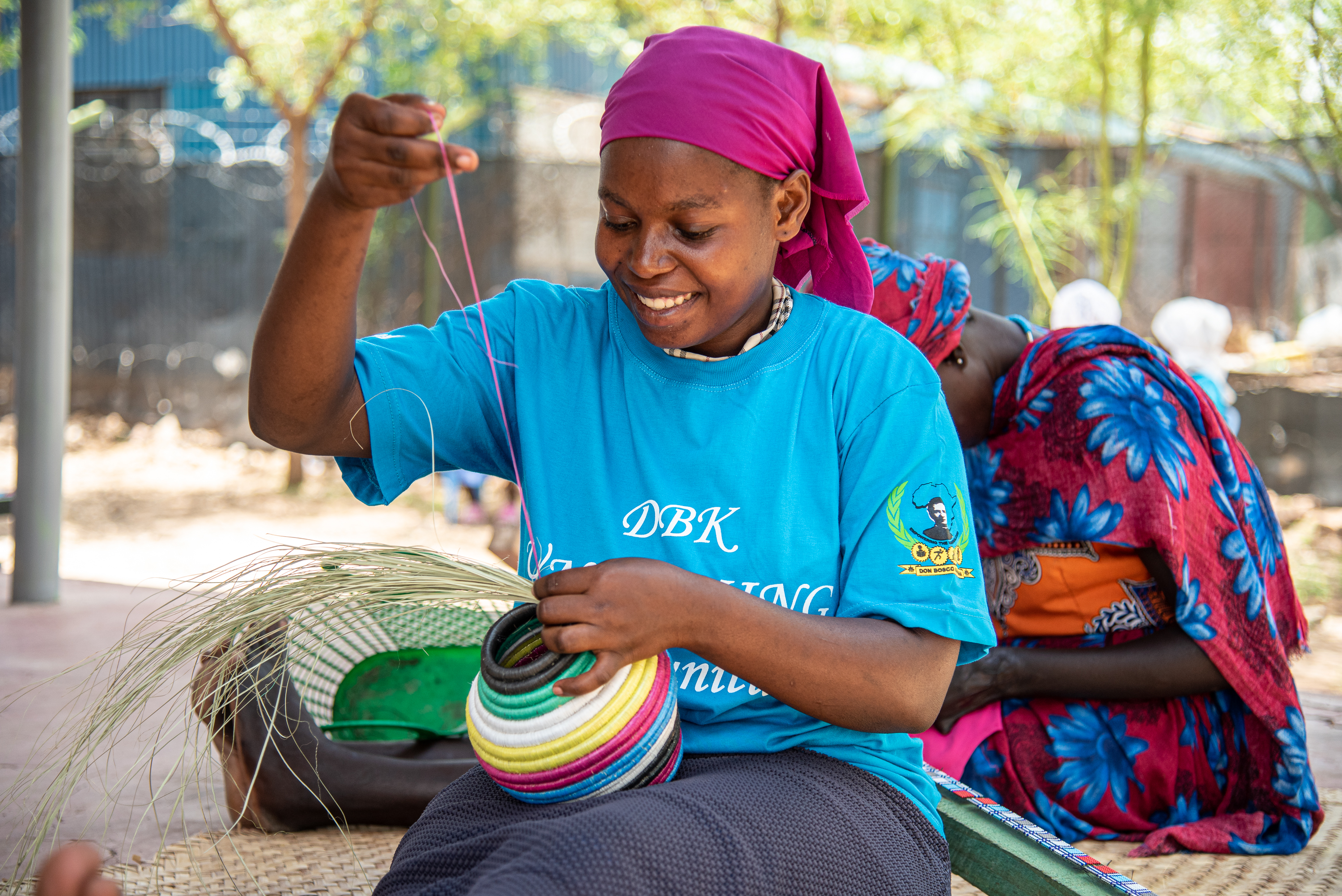   Jonanise, a beneficiary of the LEAP project, works on a basket at the Kalobeyei Business center. She received training on basket making through the project and her products are marketed at the center and through implementing partner Don Bosco's network of centers