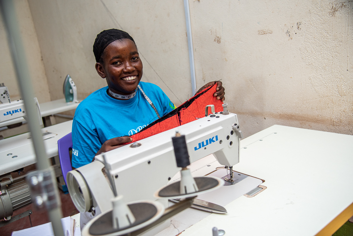 Bella, a beneficiary of the LEAP project, works on a dress at the Kalobeyei Business center. She received training on tailoring through the project and her products are marketed at the center and through implementing partner Don Bosco's network of centers. (Photo: UN Women/James Ochweri) 