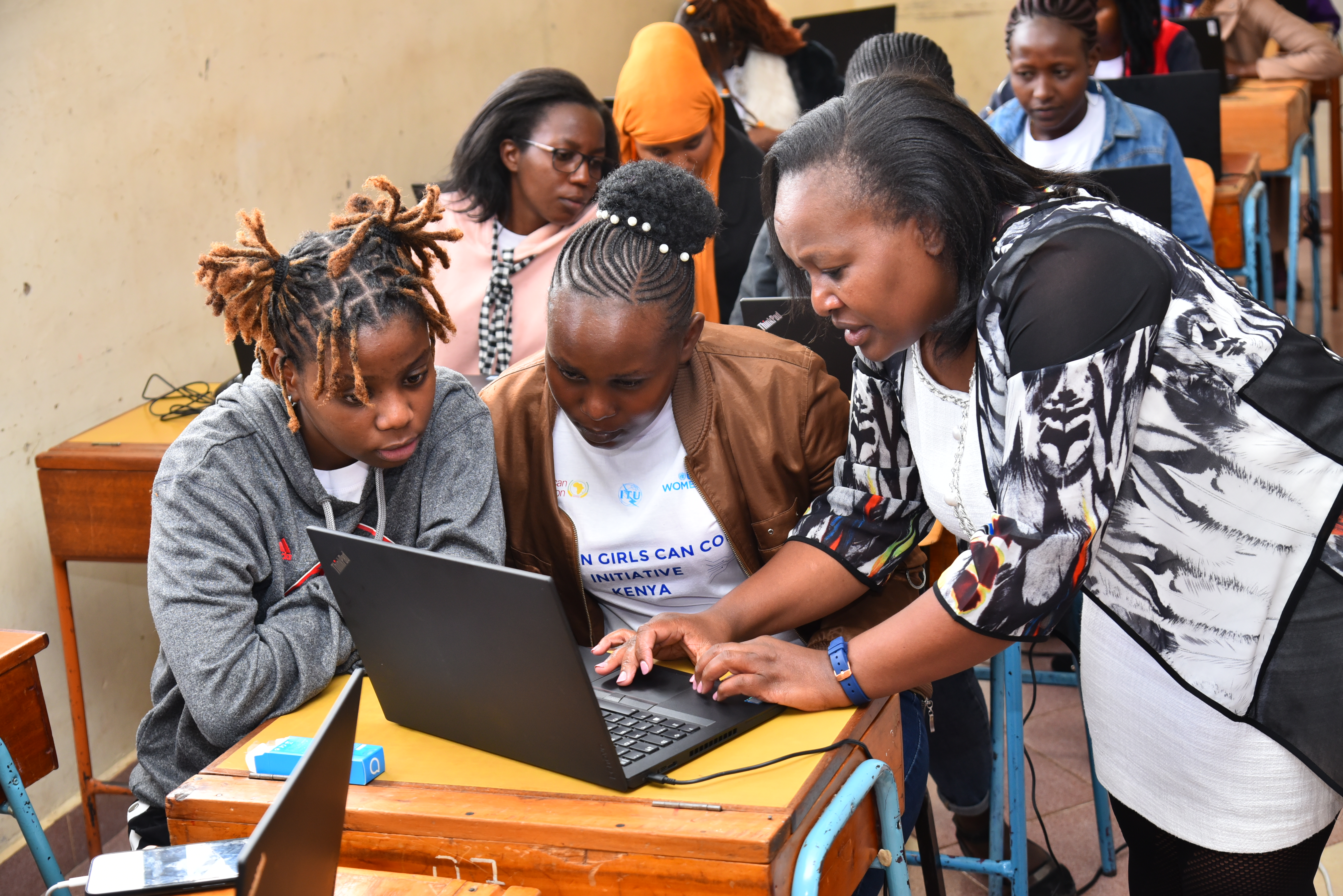 Trainer with students during Kenya's first AGCCI Coding Camp. Photo: UN Women/Clinton Awii