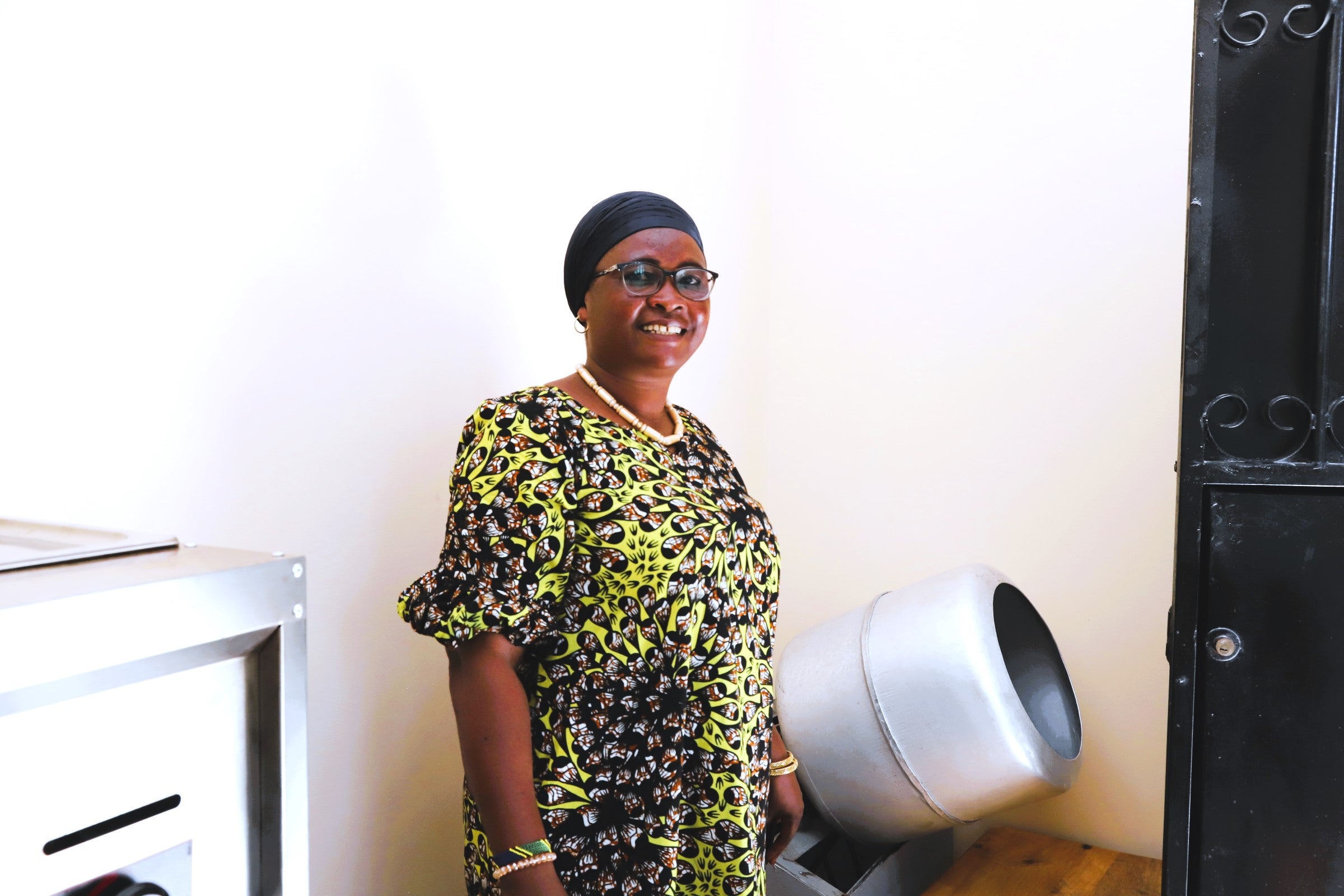 Ms. Sophia Chove with her snack-making equipment in her home-based small factory in Dar es Salaam. Photo: UN Women