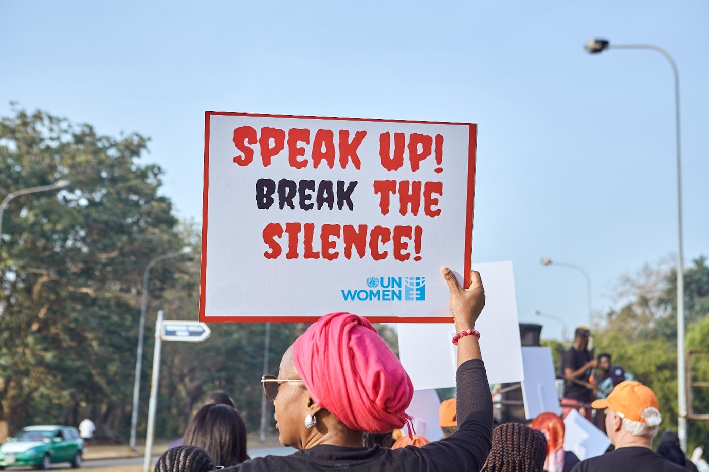 UN Women staff raises a placard during a walk against GBV in Abuja, Nigeria.  Photo: UN Women Nigeria
