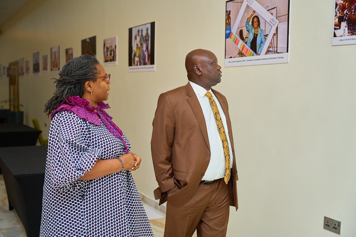  Hon Minister of Peacebuilding South Sudan, Mr. Stephen and Korto UN Women team member during the Photo Exhibition. Photo: UN Women Sudan