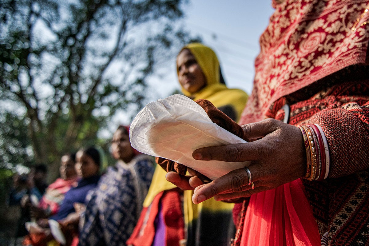 In Sitamarhi State, Bihar, India, in 2022, women hold sanitary pads during an awareness campaign as part of a menstrual hygiene management program organized by UNICEF. Photo: UNICEF/Priyanka Parashar