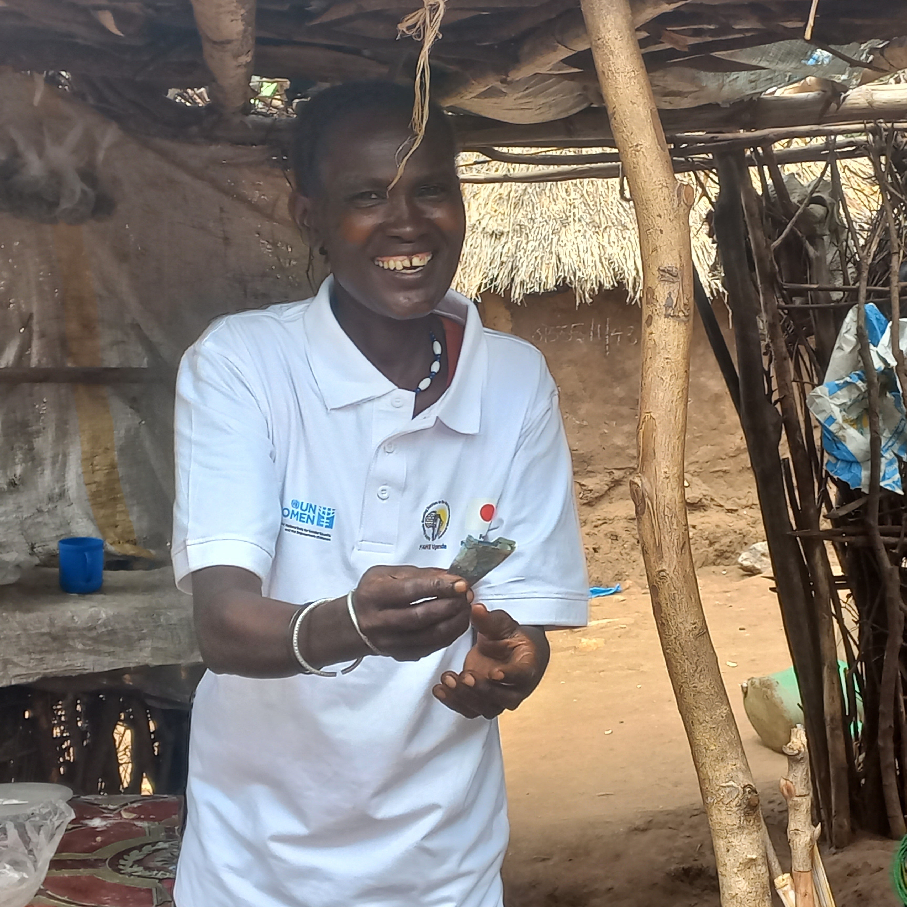 Selina displays some money after selling chapatis to a customer.