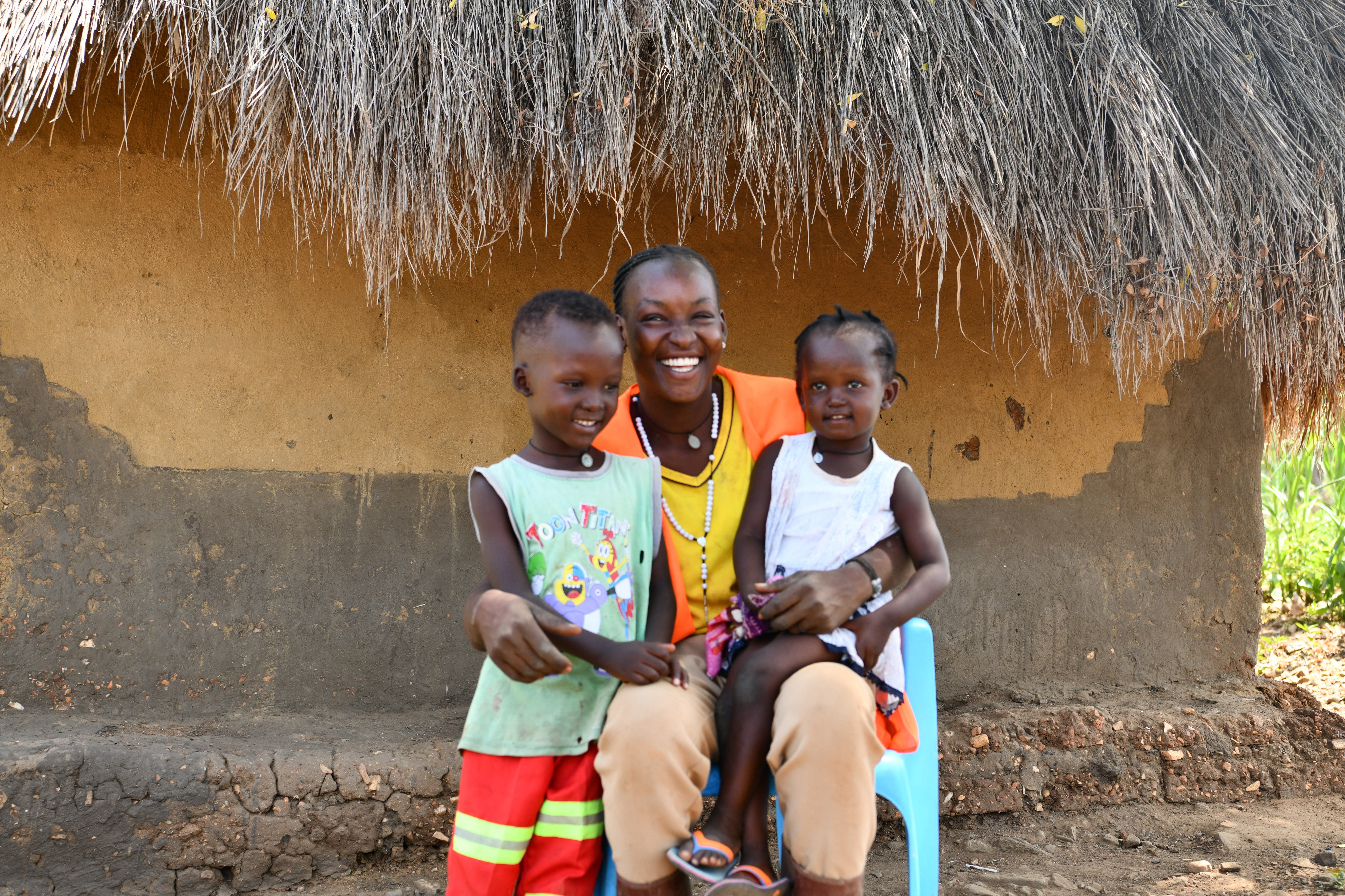Poni in a light moment with her 2 children in Imvempi Refugee Settlement, Terego District