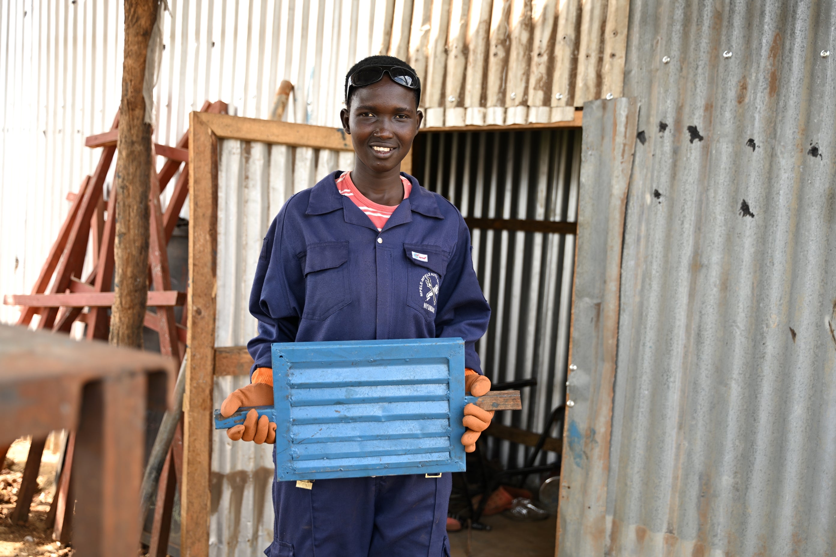 Veronica Konga, a host community member at Nyumanzi settlement, with one of the products she welded as part of her training. . (Photo: UN Women/James Ochweri)