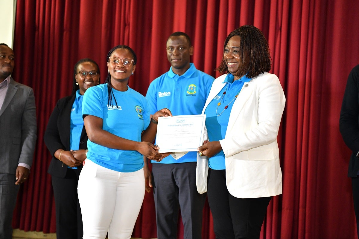 UN Women Representative, Ms. Jennet Kem, handing over a certificate to Cynthia Isimbi at the graduation ceremony.