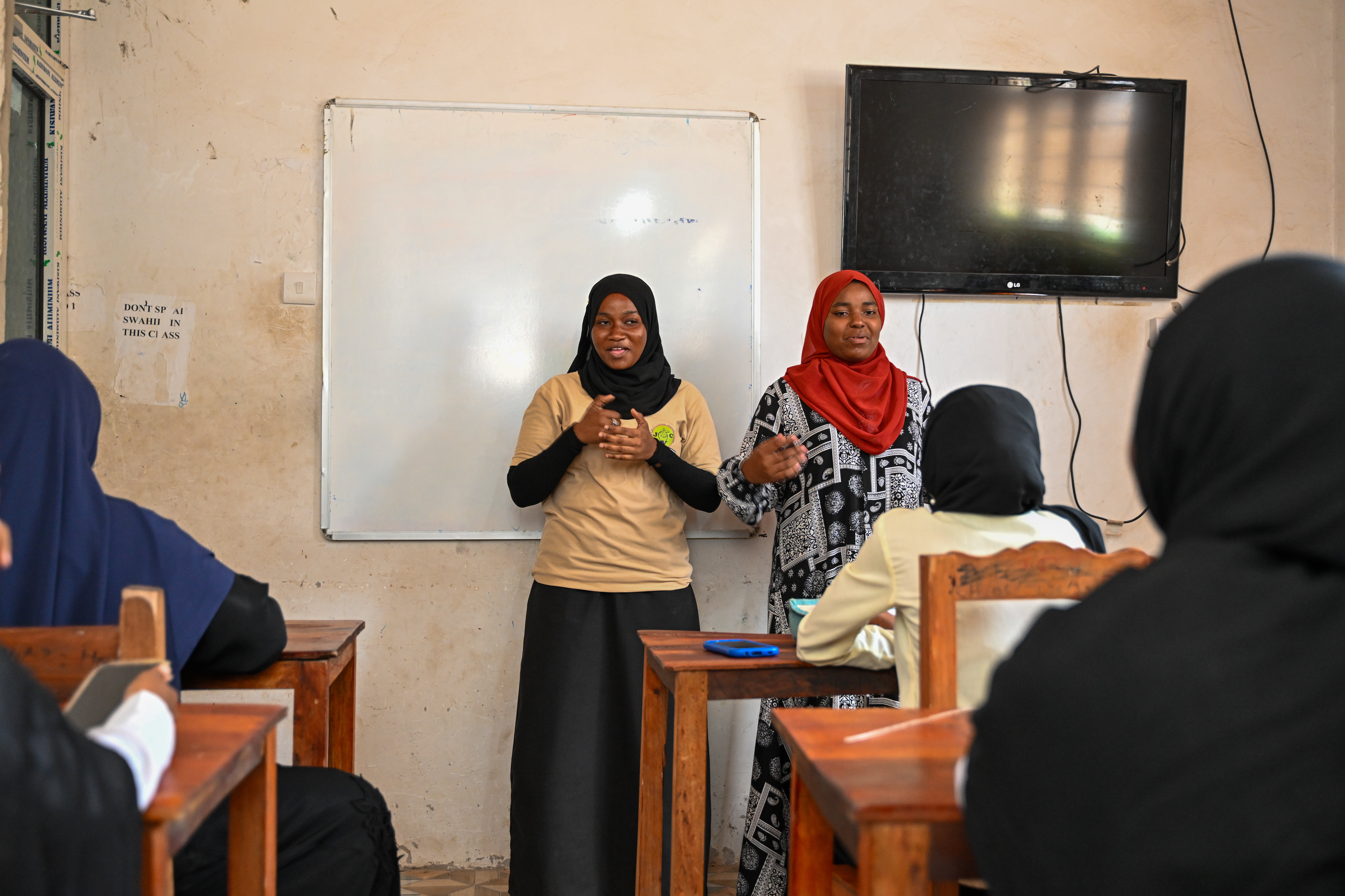 (Left to right) Maryam and Asma training a cohort of sign language students at the Inclusive Vocational Training Center in Mambosasa village, Zanzibar. (Photo: UN Women/James Ochweri)