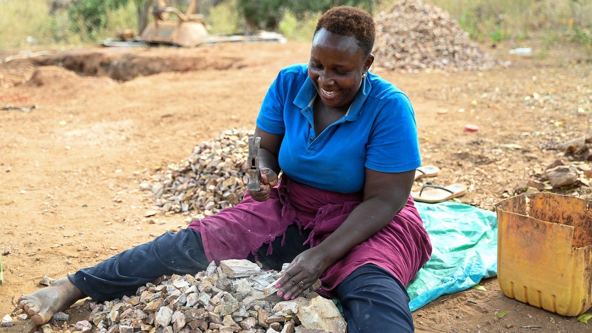 Peninah Mbithi diligently breaking stones as part of her daily routine to make a living. Photo: UN Women/James Ochweri