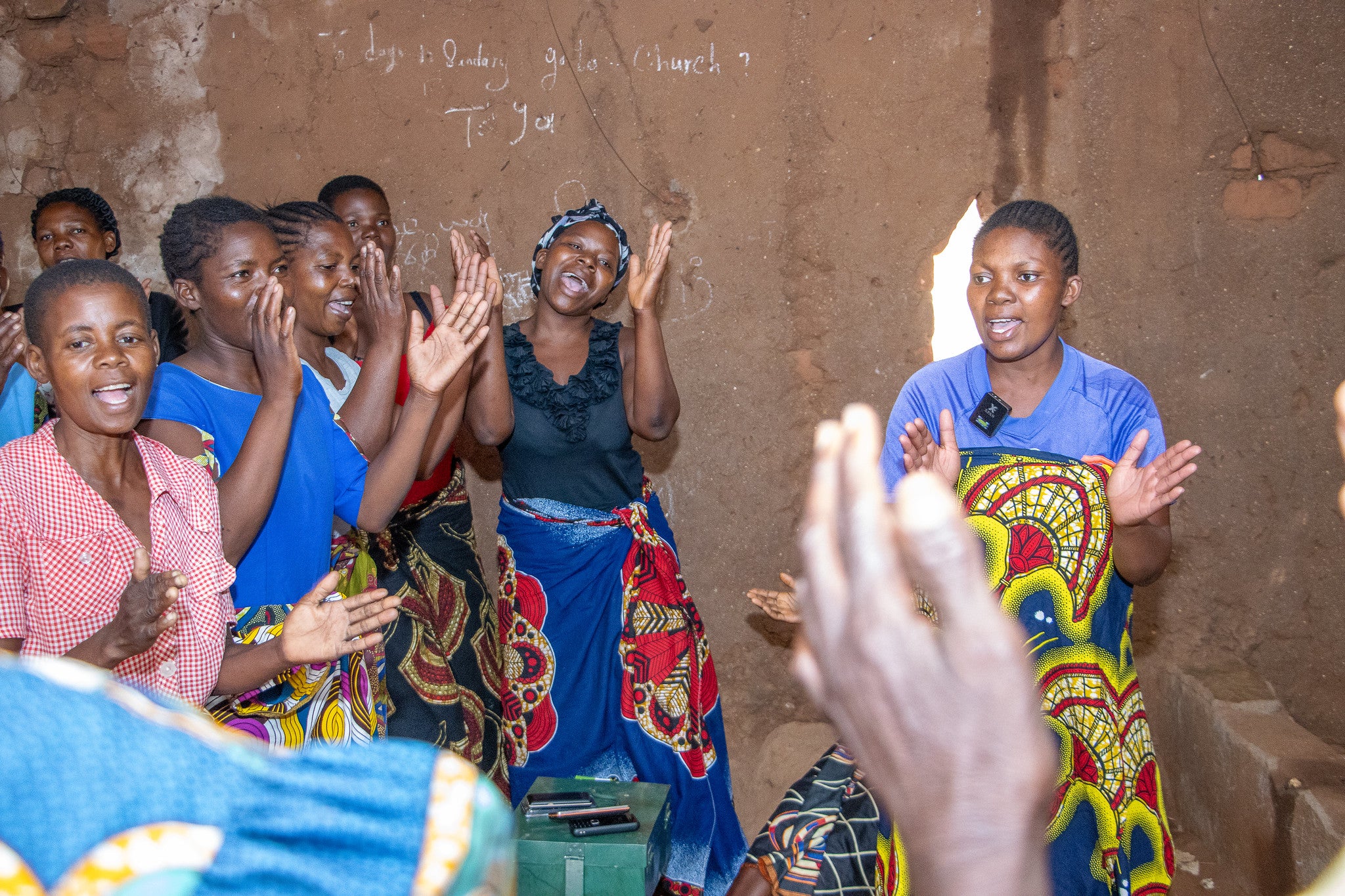 Women singing at a community meeting. Photo: UN Women Malawi