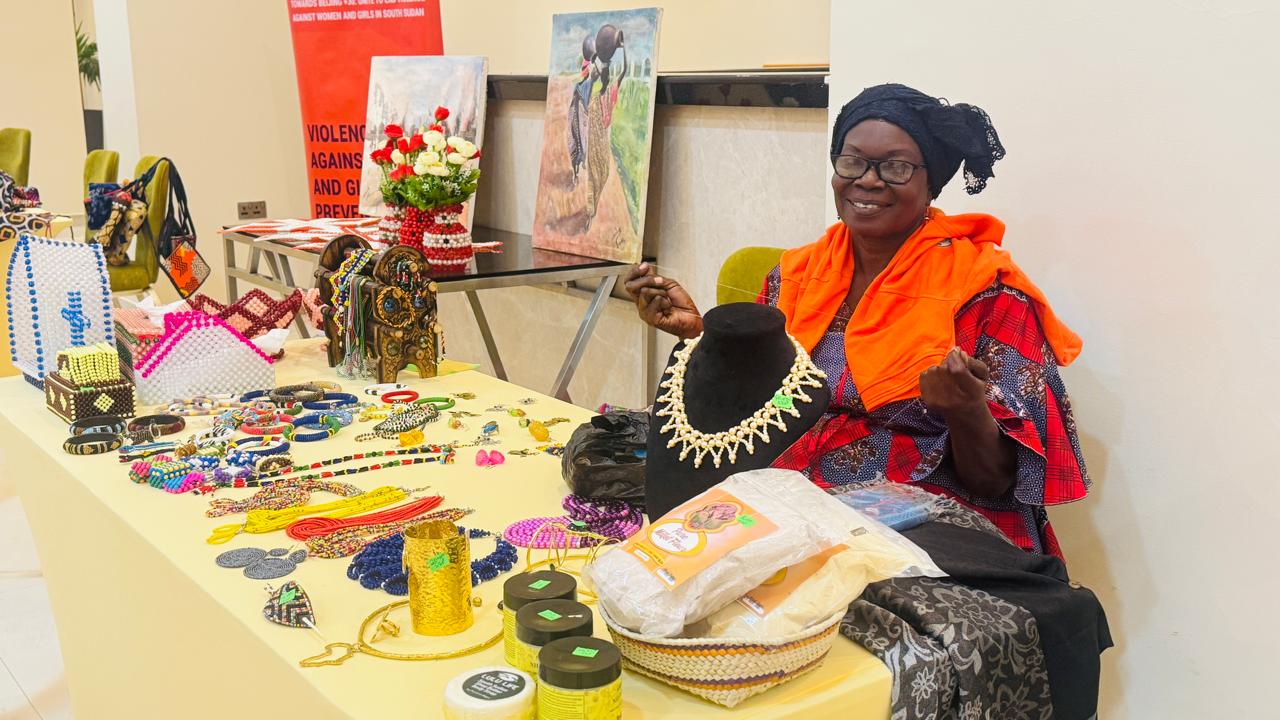 A woman showcases her products during the UN joint event for the 16 Days of Activism campaign in Juba.