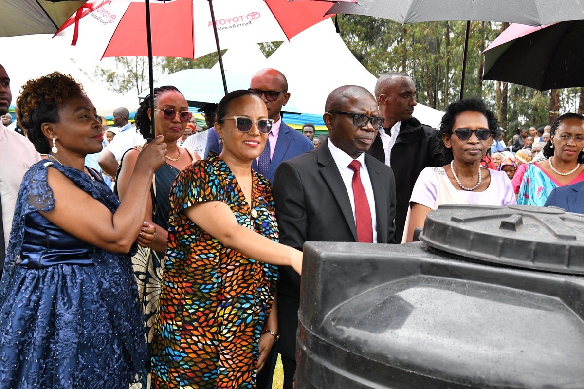 (From second left) Tikikel Tadele Alemu, UN Women Programme Management Specialist, Christophe Nkusi, Mayor of Ngororero district (M) and Speaker of Parliament, Hon. Gertrude Kazarwa, handing over water tanks to select families.