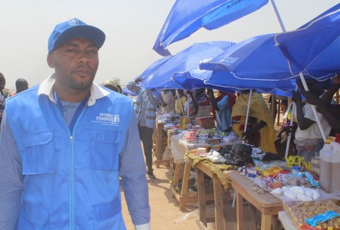 Jimmy Henry N. assisting female refugees on rapid income generating activities at the Minawao refugee camp