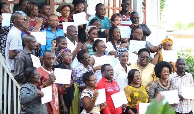 Cross section of participants pose for family photo at the end of training