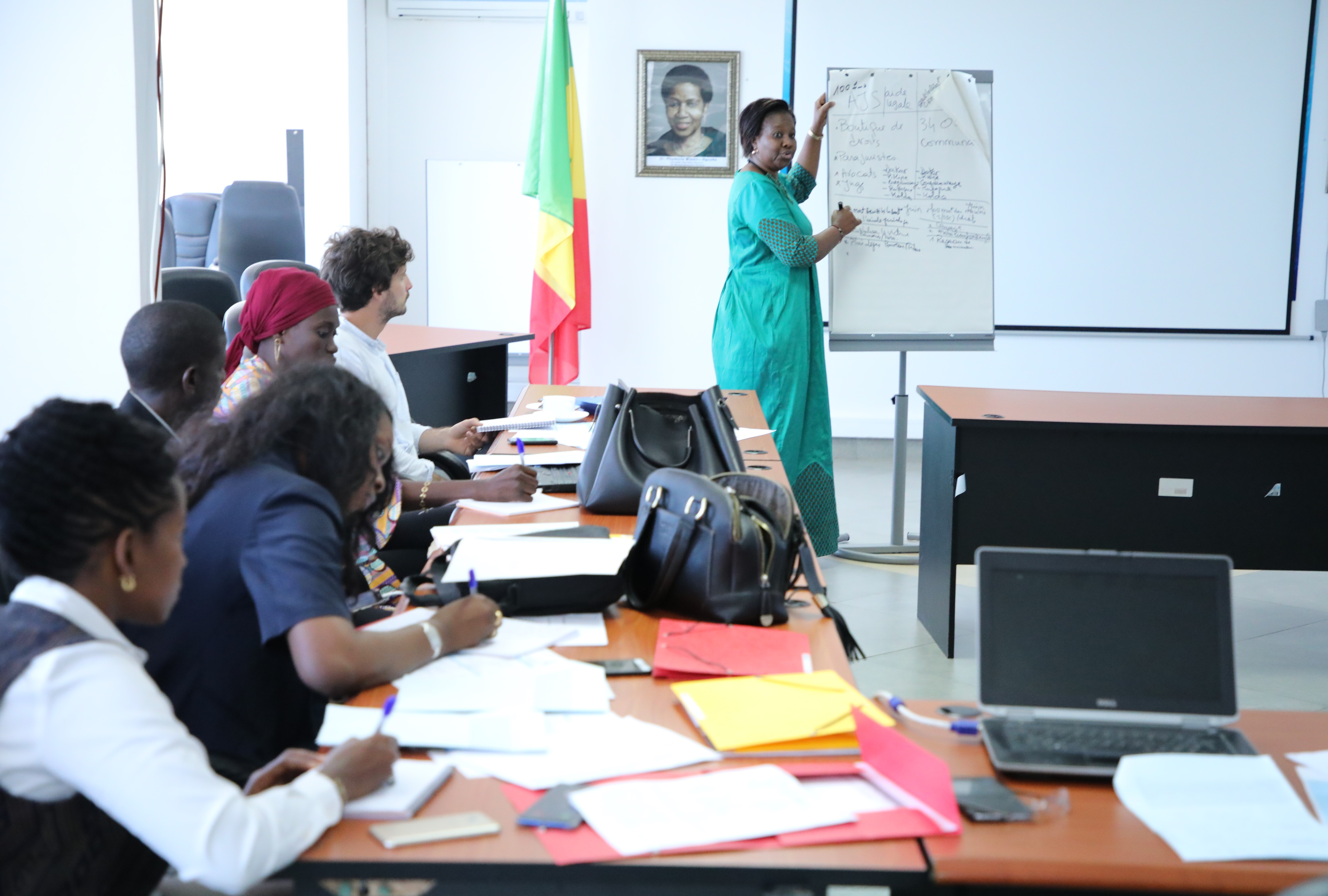 Marie Sabara, EVAW Program Officer presents the "Improving access to legal aid for women" project in front of representatives from sister UN agencies, civil society and Government.