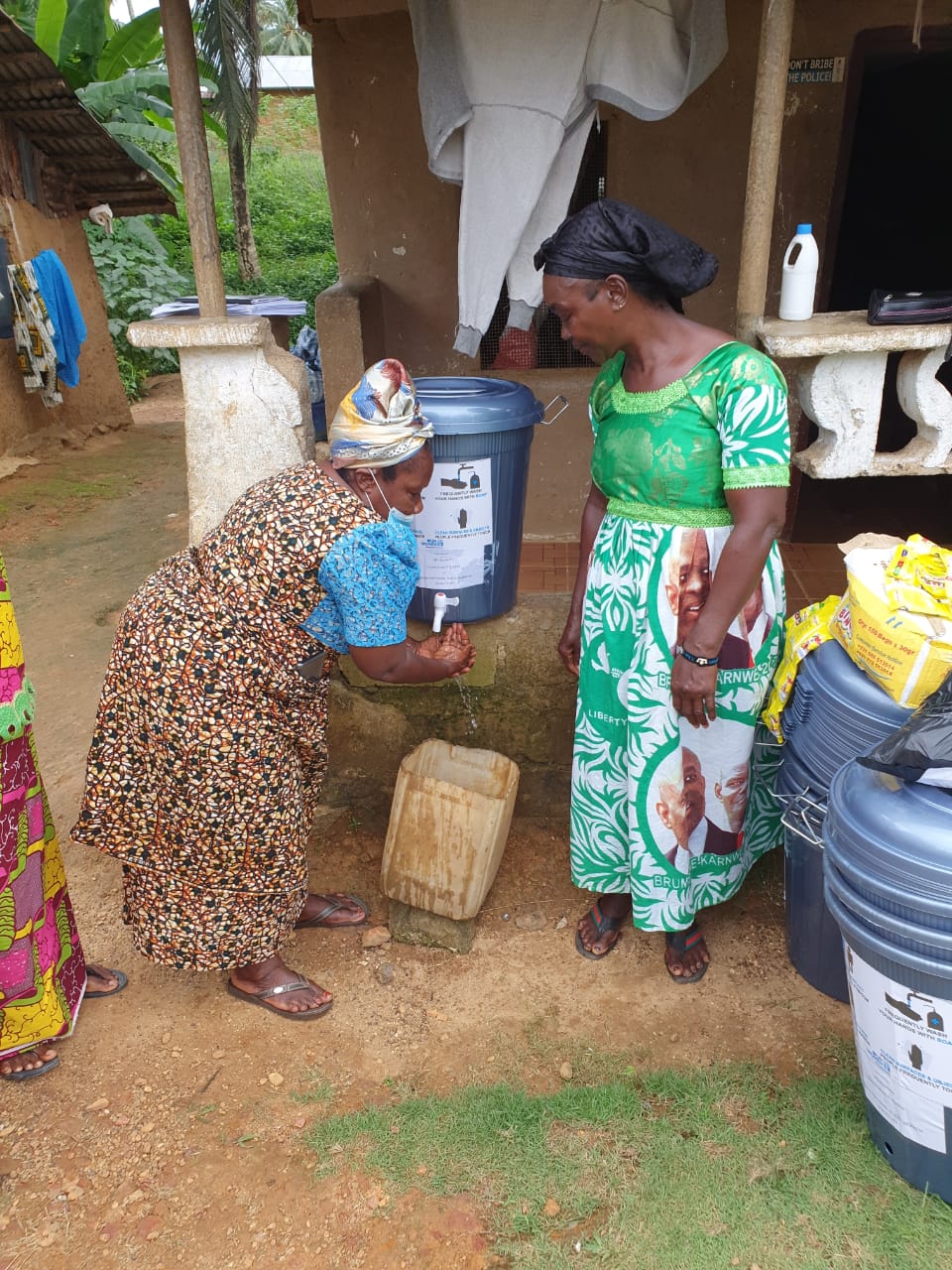 Mrs. Kebeh Monger, National President of the Rural Women Structure of Liberia demonstrates how to wash hands to prevent the spread of COVID-19.