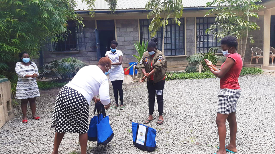 Distribution of dignity packs to quarantine and isolation facilities in Kiambu Hospital in Kenya to women by the County director for gender and health officials