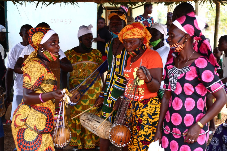 Traditional practitioners in Liberia playing traditional music to welcome guests. Photo credit - UN Women Liberia