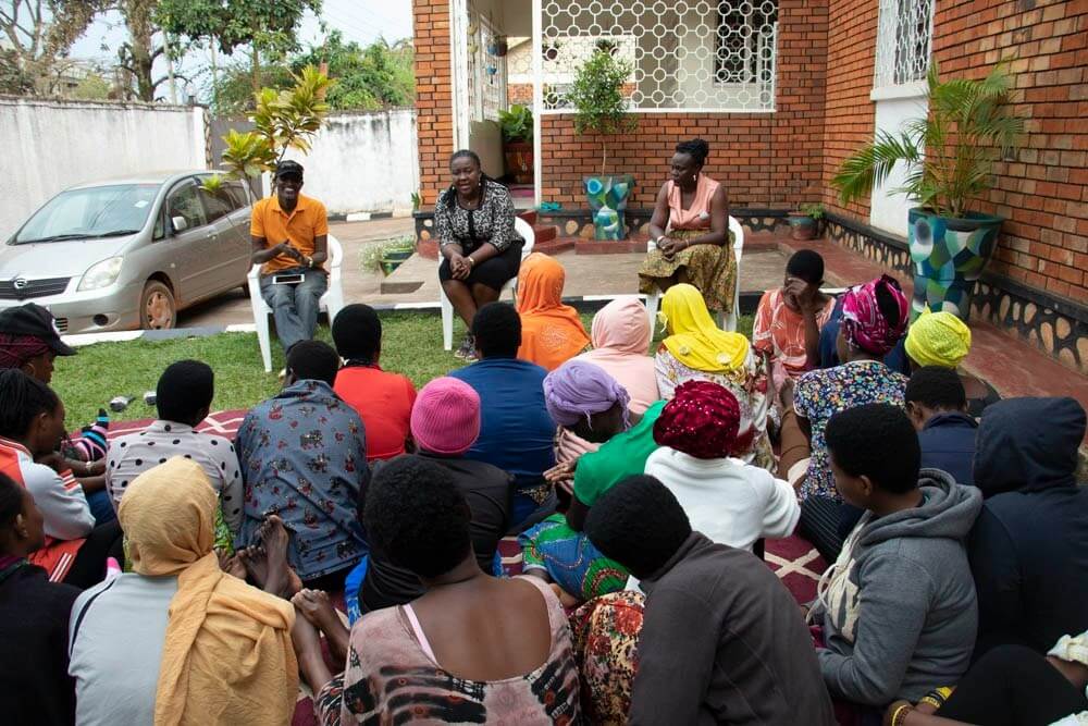 Prior to the departure of the 32 human trafficking survivors from Burundi, UGANET staff with interpretation support shared some final words of encouragement after their stay at the shelter (UGANET). Photo: UN Women/Eva Sibanda.
