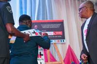 Edo State Governor Hon. Ben Ayade signs the He for She plaque. Photo: UN Women/ Olanrewaju Faremi