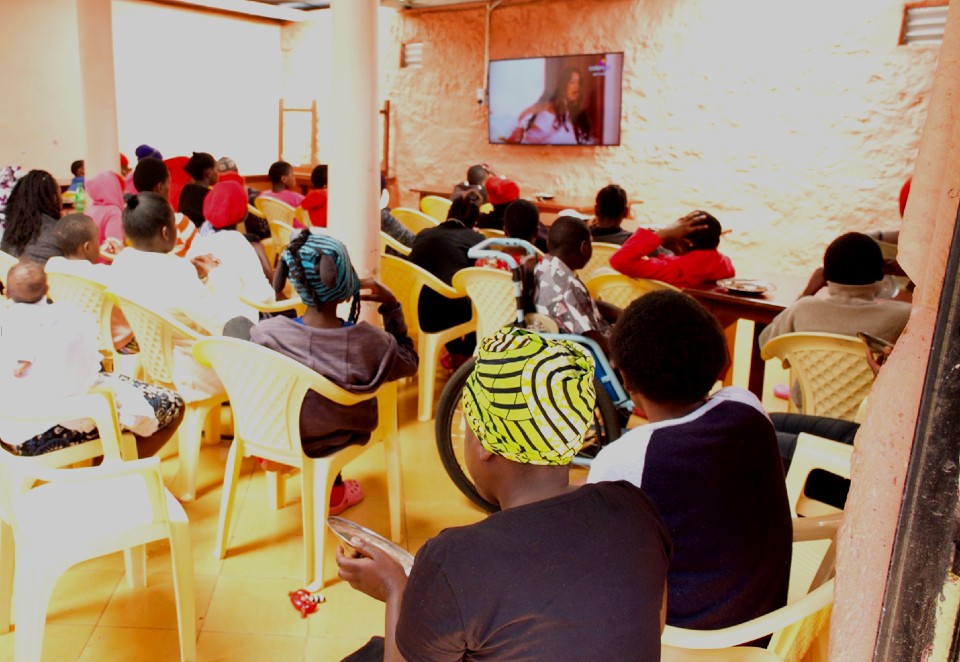 Its time to relax and watch a show at one of the shelter in Nairobi. Photo credit, UN Women/ Ben Brewster