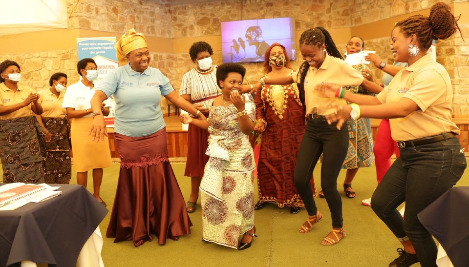 The Minister in charge of gender and the UN Women Representative in Burundi doing some dance steps with participants to the rhythm of the song 'Umukenyezi on women's rights