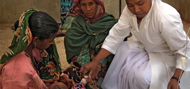 A woman doctor tends to a young woman. Photo: UN Women/Mohammad Rakibul Hasan