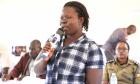 Beatrice Akello pictured speaking holding a microphone during the capacity building training in Soroti captured by UN Women Eva Sibanda