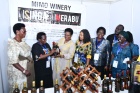 (Centre) Gender Minister, Hon. Betty Amongi admires some locally produced wine from Mimo Wines Company based in Mukono district as UN Women Country Representative Dr. Paulina Chiwangu and State Minister of Fisheries Hellen Adoa (left) plus other officials look on.