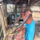 Selina, at the makeshift shelter where she makes and sales chapatis. Selina envisions buying land and establishing a restaurant. Photo Credit: UN Women / Allen Ankunda