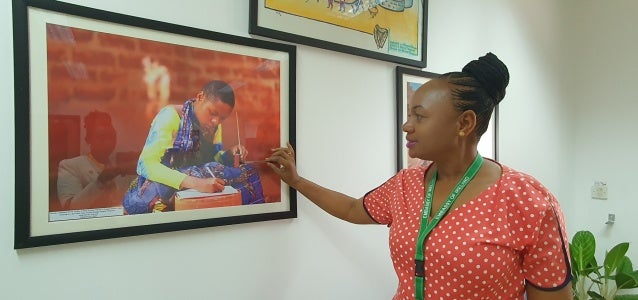 A lady looking at an image on a wall