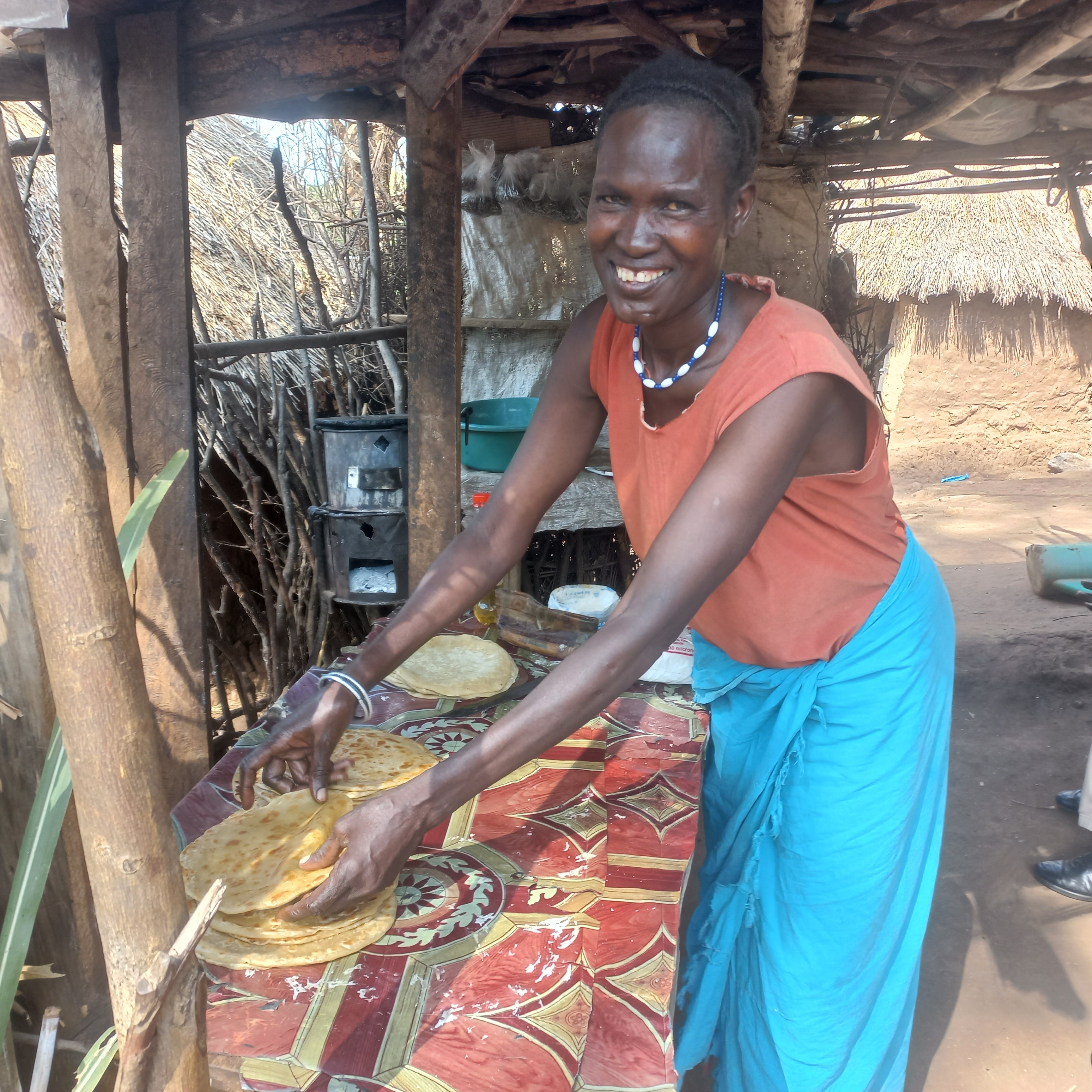 Selina preparing chapatis in her makeshift stall in Moroto. Photo credit: UN Women / Allen Ankunda